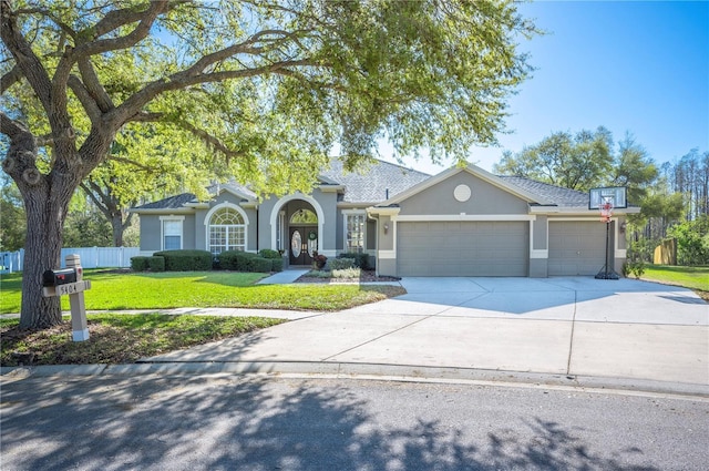 single story home featuring stucco siding, a front lawn, fence, concrete driveway, and a garage