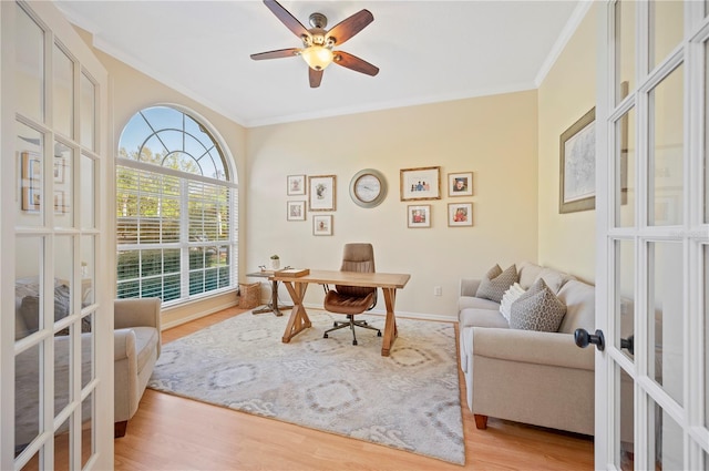 office featuring french doors, crown molding, ceiling fan, and wood finished floors