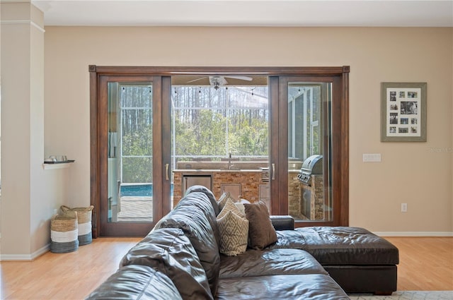 living room with baseboards and wood finished floors