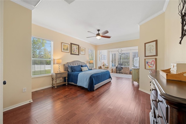 bedroom featuring dark wood-type flooring, crown molding, and baseboards