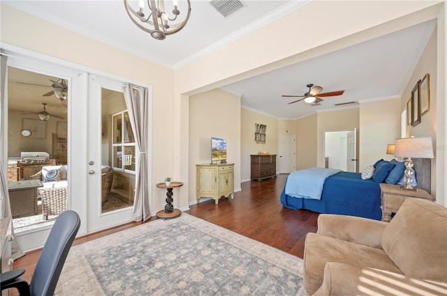 bedroom with dark wood finished floors, visible vents, a notable chandelier, and ornamental molding