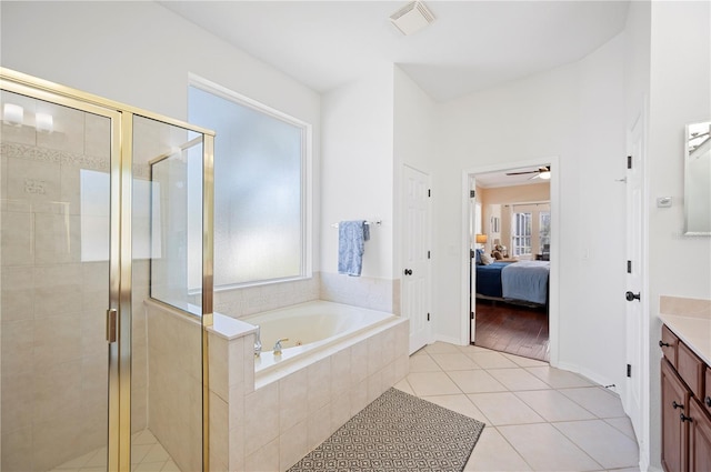 bathroom featuring a garden tub, connected bathroom, a shower stall, tile patterned flooring, and vanity