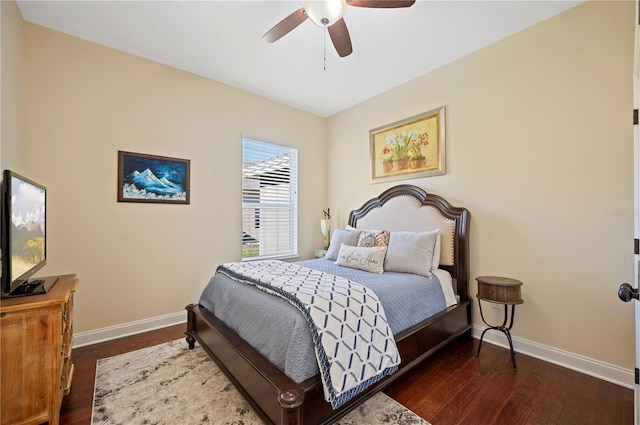 bedroom with ceiling fan, baseboards, and wood finished floors