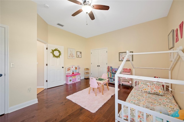 bedroom featuring visible vents, baseboards, and wood finished floors