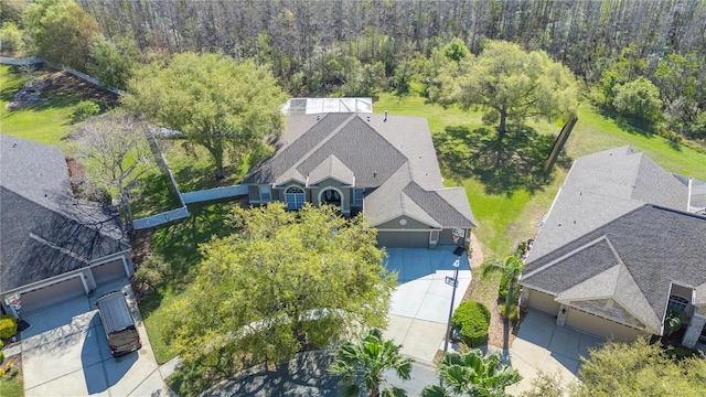 birds eye view of property with a view of trees