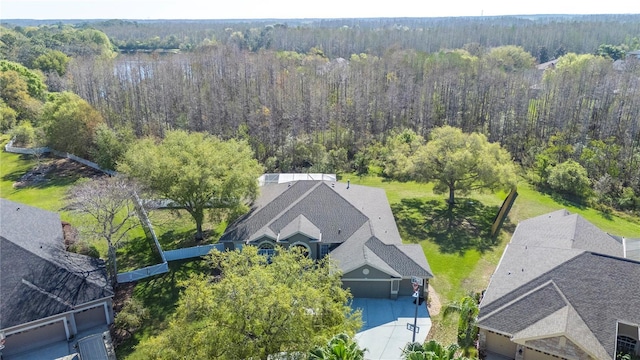 drone / aerial view featuring a wooded view