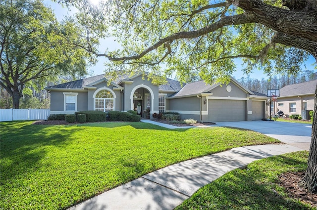 ranch-style home with stucco siding, driveway, a front lawn, fence, and an attached garage