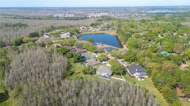 aerial view with a view of trees, a water view, and a residential view