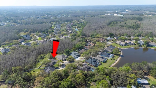 bird's eye view with a residential view, a wooded view, and a water view