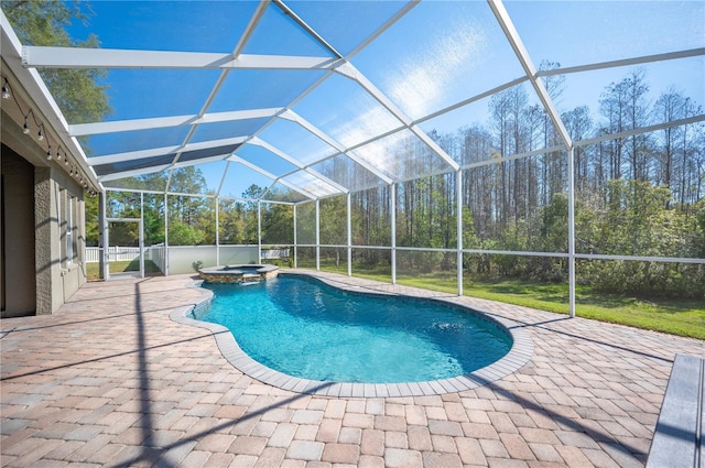 view of pool featuring a patio, a pool with connected hot tub, and a lanai