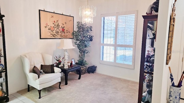 living area with a chandelier, baseboards, and carpet floors