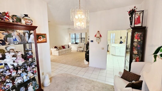 interior space with tile patterned flooring, a notable chandelier, and carpet