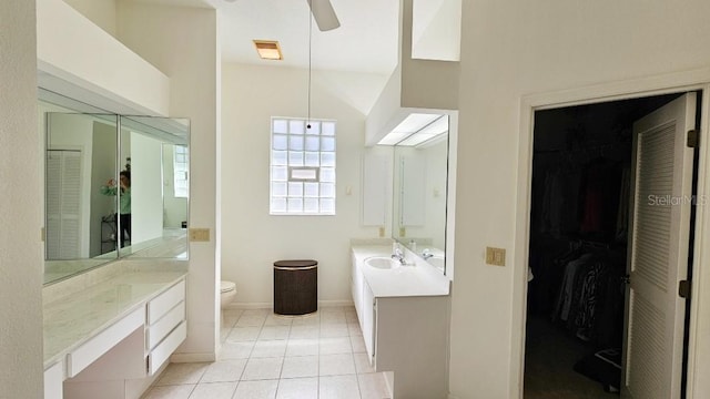 bathroom featuring tile patterned floors, two vanities, a ceiling fan, and a sink
