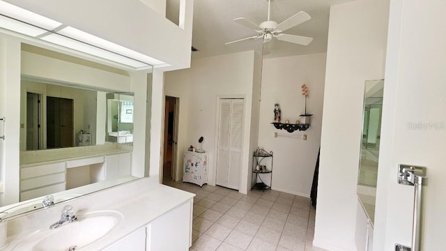 bathroom with vanity, tile patterned floors, a high ceiling, and ceiling fan