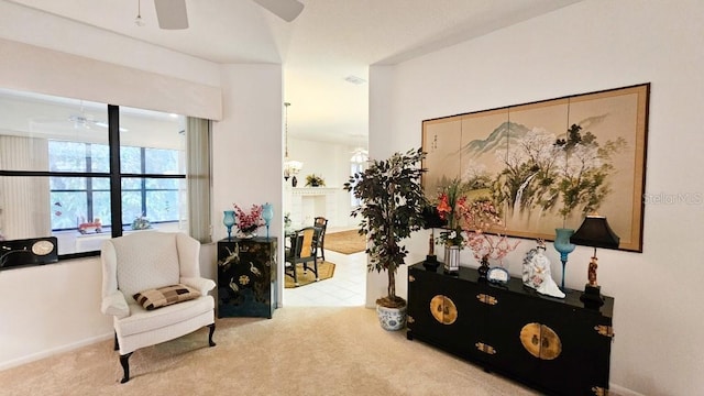 sitting room with carpet floors and a ceiling fan