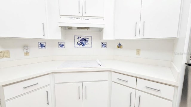 kitchen featuring white stovetop, white cabinetry, light countertops, and extractor fan