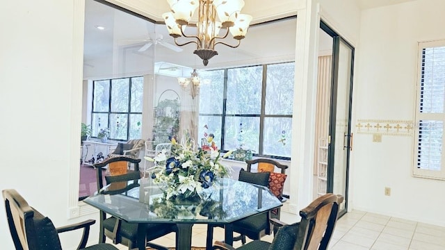 dining space with a wealth of natural light, tile patterned flooring, and ceiling fan with notable chandelier