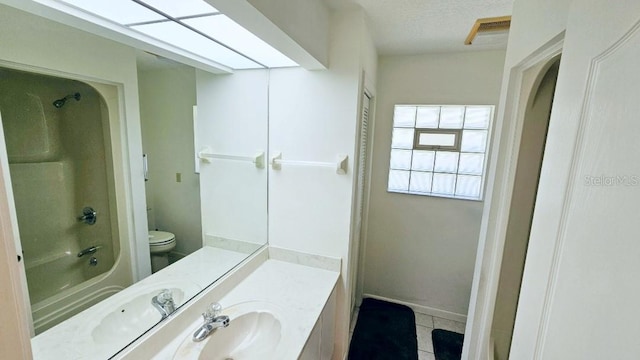 bathroom featuring vanity, visible vents, tile patterned floors, toilet, and shower / bathtub combination