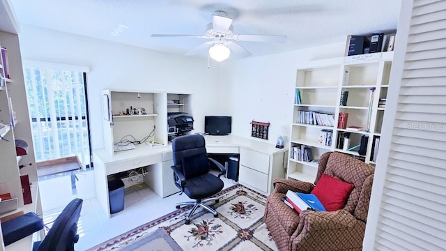home office featuring tile patterned floors and a ceiling fan