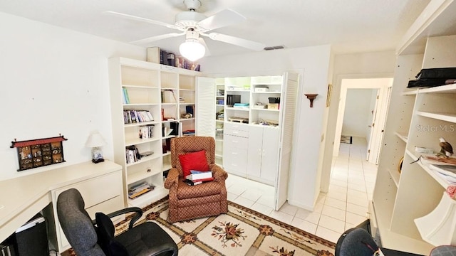 sitting room featuring tile patterned floors, visible vents, and ceiling fan