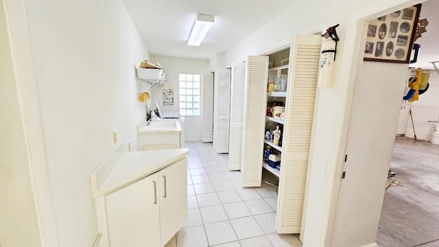 hallway featuring light tile patterned flooring