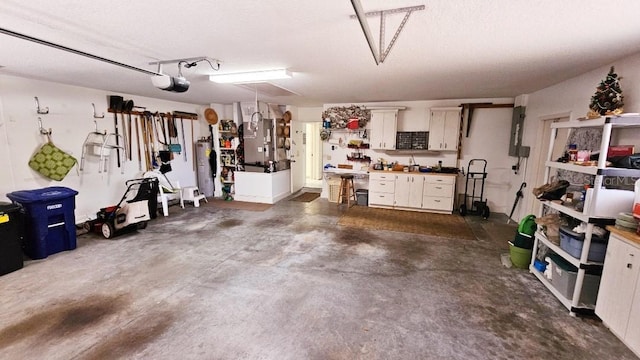 garage with water heater, a garage door opener, and electric panel