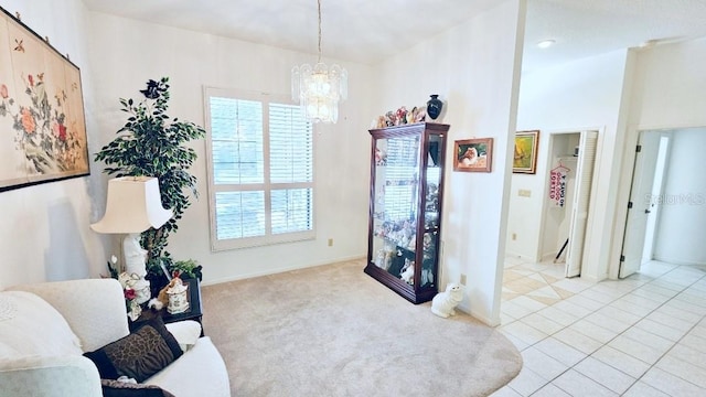 sitting room featuring baseboards, carpet floors, a notable chandelier, and tile patterned flooring