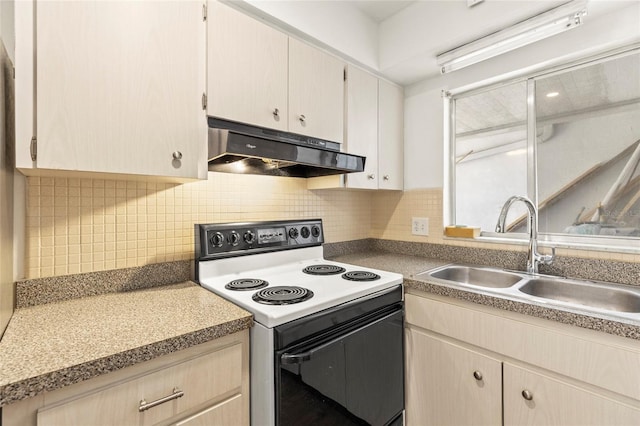 kitchen with under cabinet range hood, tasteful backsplash, electric range oven, and a sink