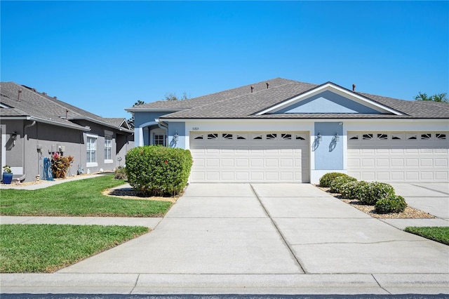 single story home featuring stucco siding, a front lawn, concrete driveway, a shingled roof, and a garage