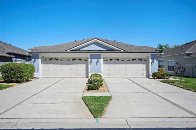 ranch-style home with a garage, driveway, and stucco siding