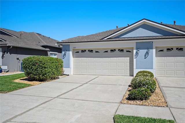 single story home featuring stucco siding, concrete driveway, an attached garage, and a shingled roof