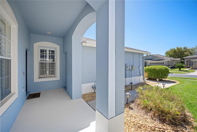 doorway to property with visible vents and stucco siding