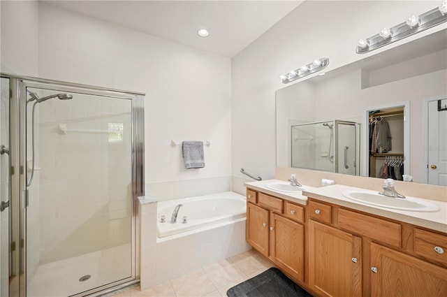 full bathroom with tile patterned floors, a shower stall, a bath, and a sink