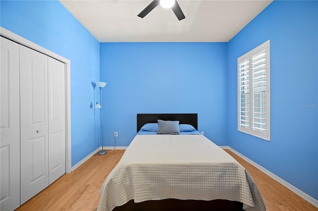 bedroom featuring light wood-style floors, a closet, and baseboards