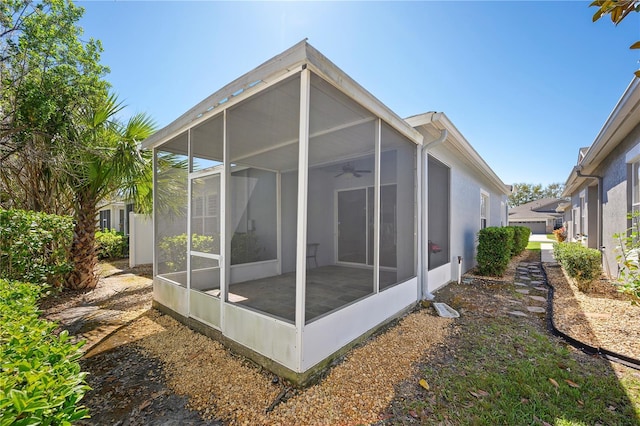 view of property exterior featuring a sunroom