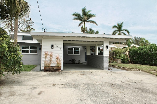 exterior space featuring an attached carport and driveway