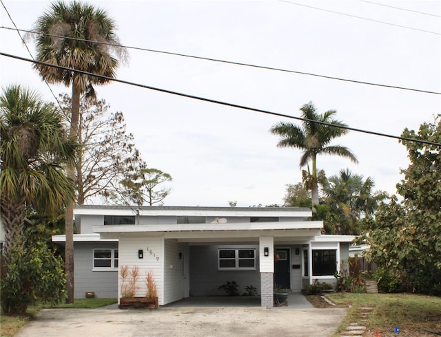 view of front of property with an attached carport and driveway