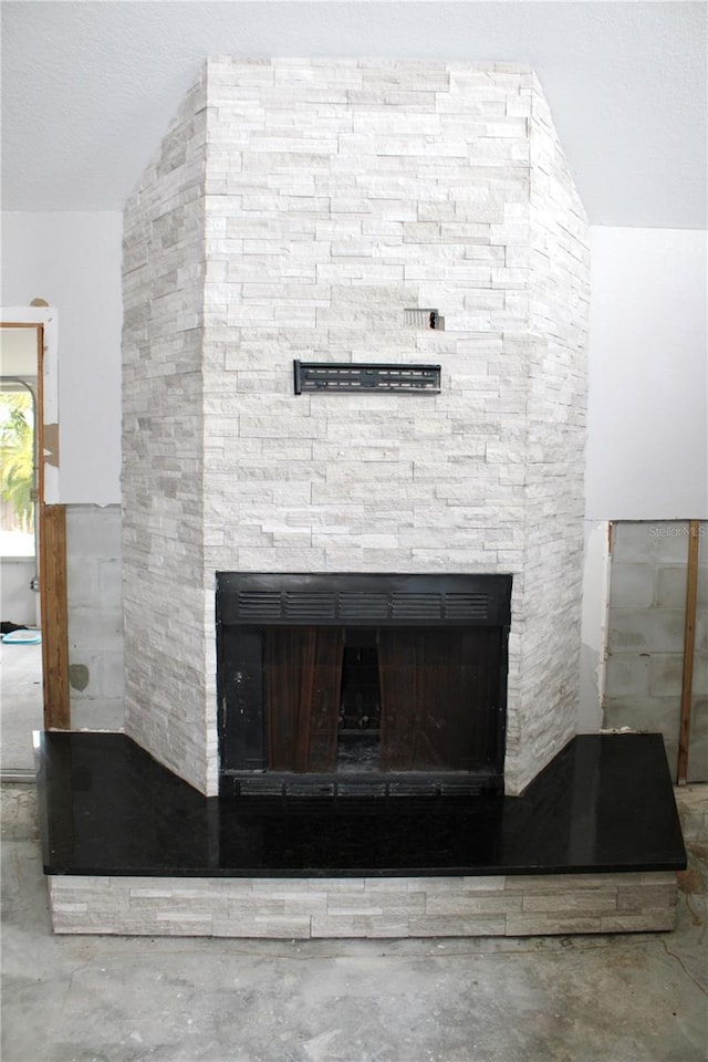 interior details featuring a stone fireplace