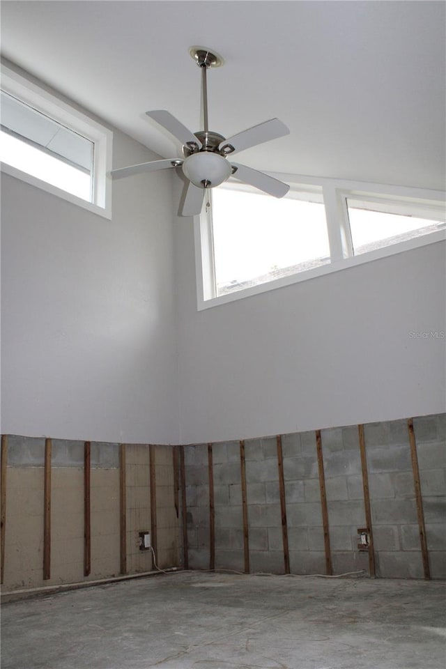 interior details with unfinished concrete flooring and a ceiling fan