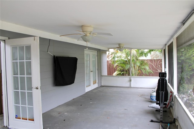 unfurnished sunroom with french doors and ceiling fan