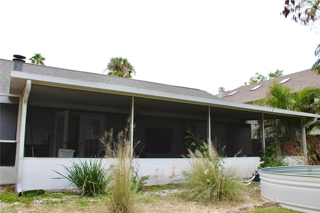 rear view of property featuring a sunroom