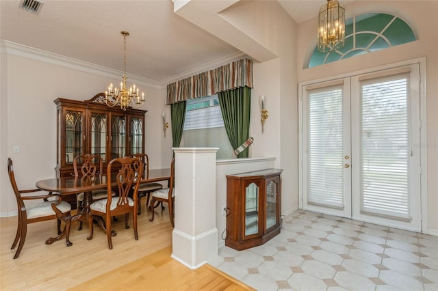 dining area featuring visible vents, french doors, an inviting chandelier, and ornamental molding