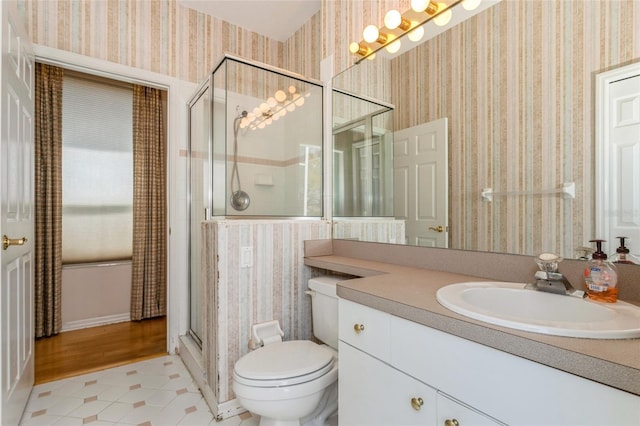 full bathroom with tile patterned flooring, a shower stall, wallpapered walls, toilet, and vanity