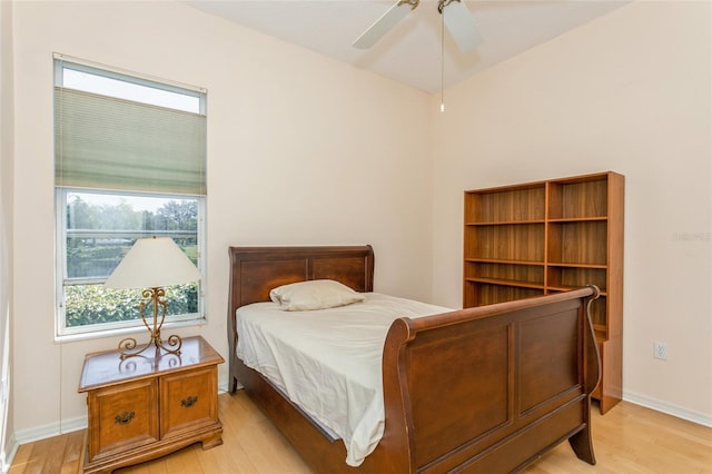 bedroom with baseboards, light wood-style flooring, and a ceiling fan