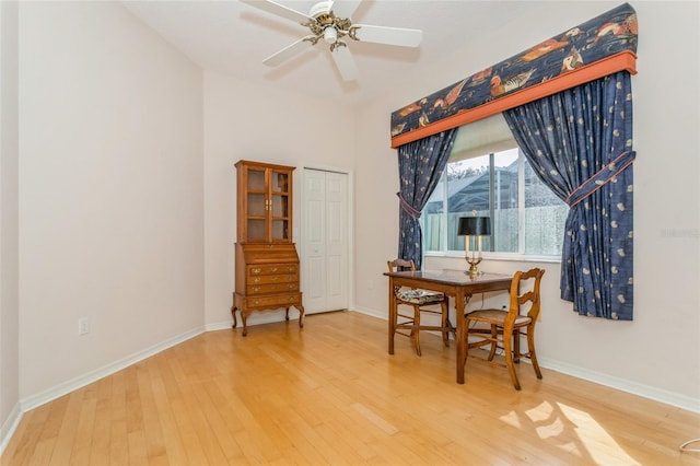 dining area featuring ceiling fan, baseboards, and wood finished floors