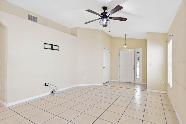 entrance foyer with visible vents, ceiling fan, baseboards, lofted ceiling, and light tile patterned floors