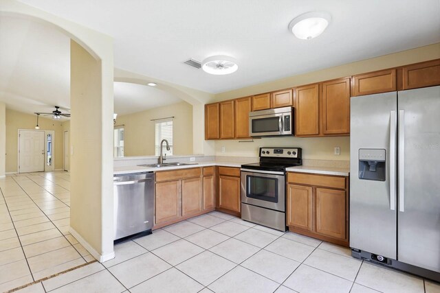 kitchen featuring visible vents, stainless steel appliances, light countertops, and a sink