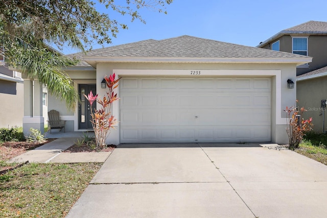 ranch-style home featuring stucco siding, concrete driveway, a garage, and a shingled roof