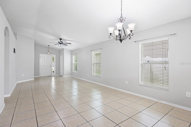 7233 Lumber Port Dr, Ruskin, FL 33573 - spare room with a chandelier, a ceiling fan, light tile patterned floors, and vaulted ceiling