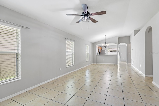7233 Lumber Port Dr, Ruskin, FL 33573 - empty room with lofted ceiling, a chandelier, ceiling fan, arched walkways, and light tile patterned floors
